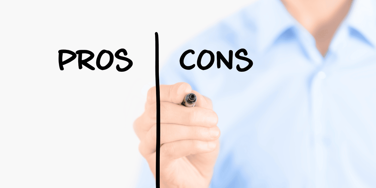 Hand writing out lists of pros and cons