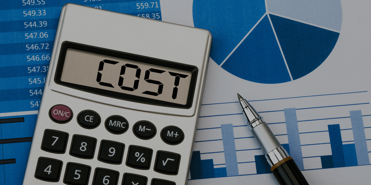 Cost displayed on calculator with graphs behind it representing the cost to start a real estate franchise