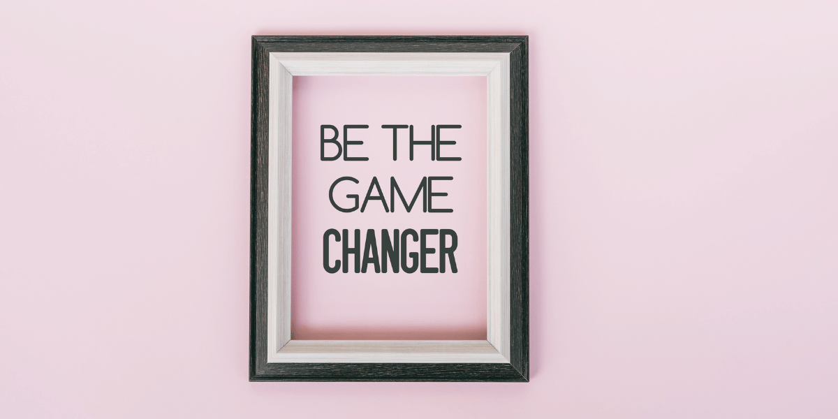 A wall with a framed note that says "Be the Game Changer"