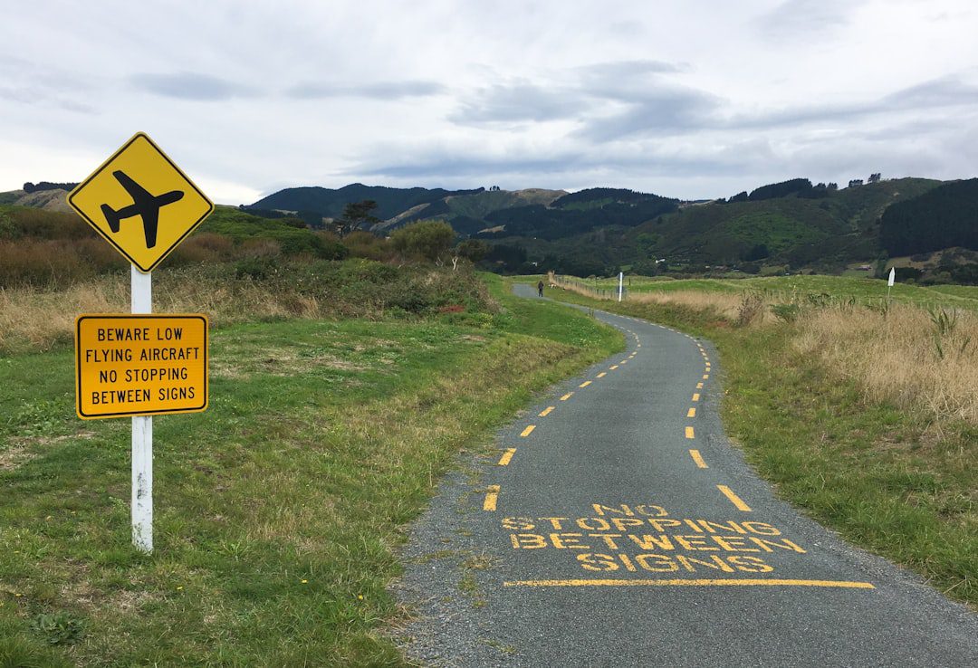 House with a 'for sale' sign in the yard.