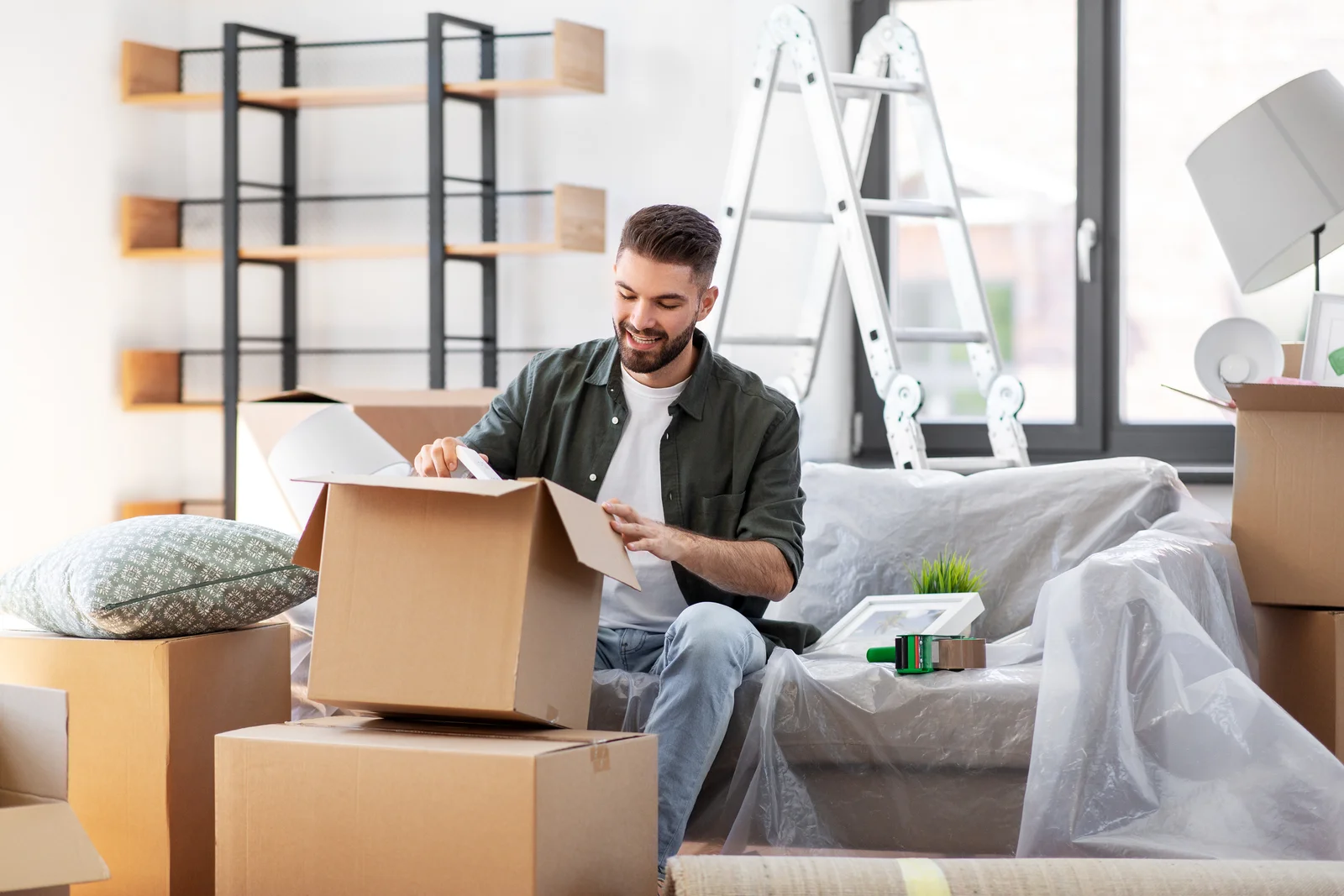Man unpacking boxes at new home 2