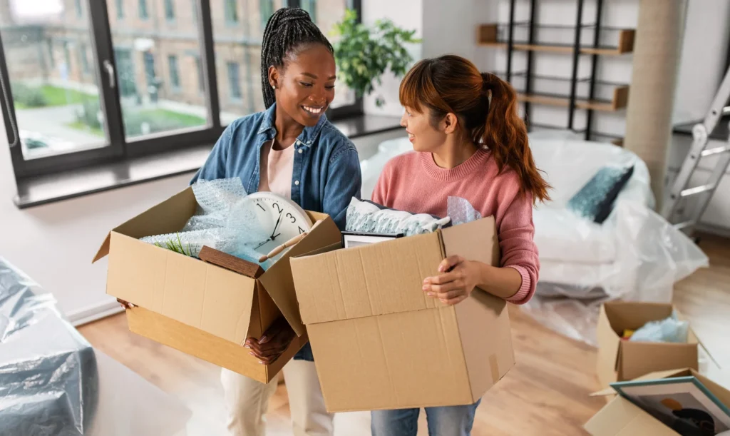 Women with boxes moving to new home