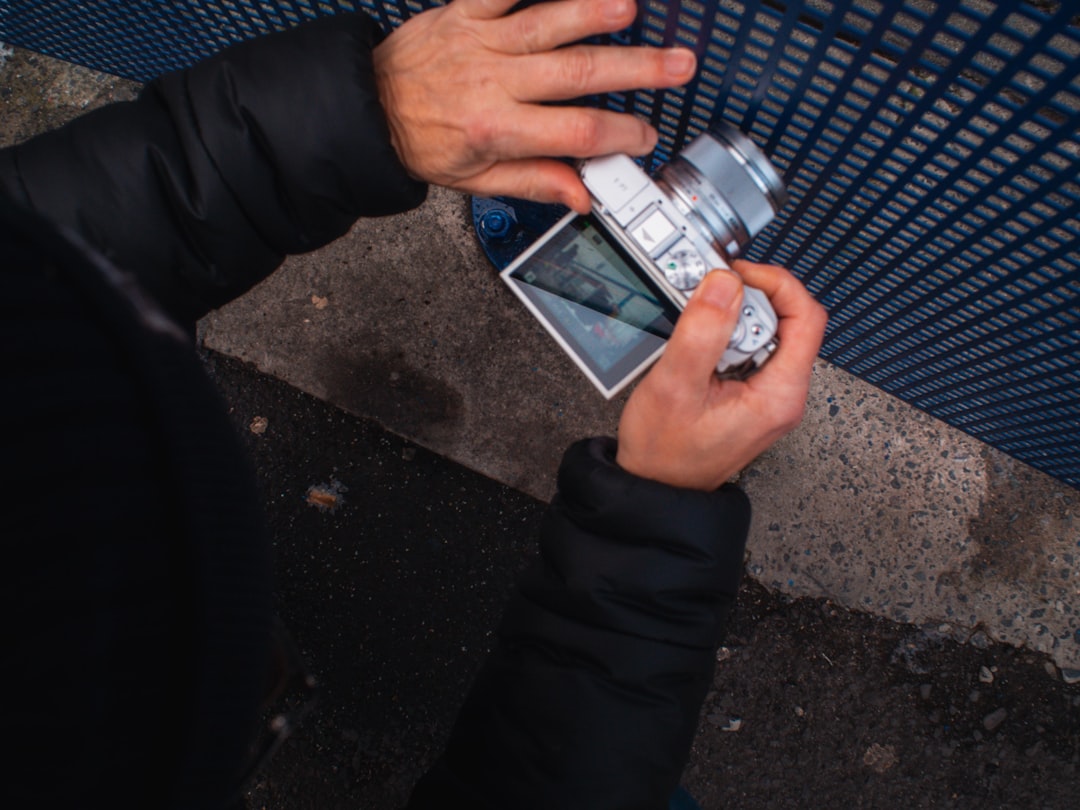 A close-up shot of a hand holding both a house key and a significant stack of cash, illustrating the tangible financial return from lower real estate fees.