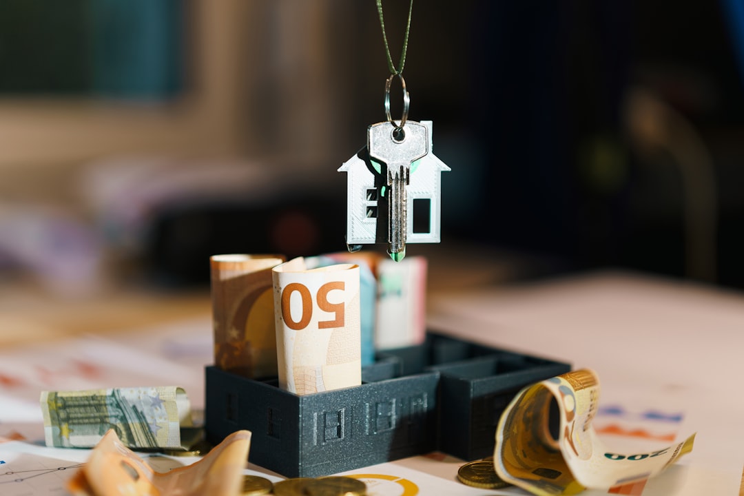 A minimalist balancing scale with a stack of coins on one side and a miniature house model on the other, illustrating a cost-benefit analysis in real estate.