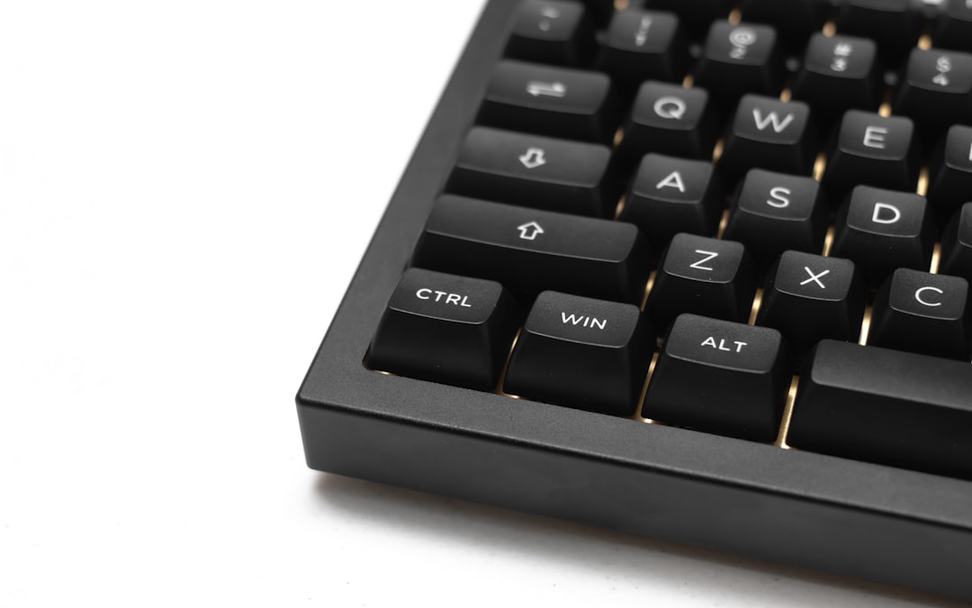 A top-down view of a person's hands using a calculator on a clean desk, with a house key and papers nearby, representing calculating real estate commission savings.