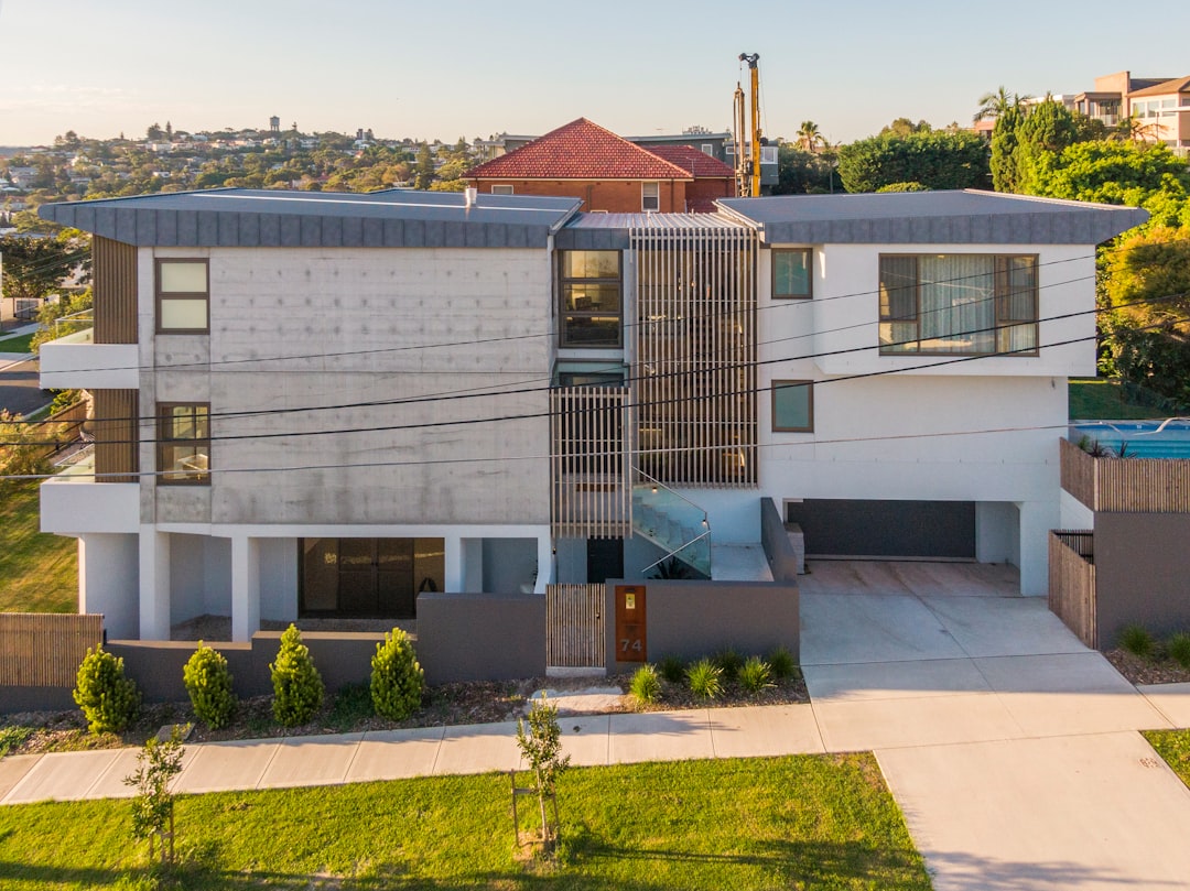 The bright, sunny exterior of a modern American suburban home in a quiet neighborhood, representing a valuable real estate asset in Central Indiana.