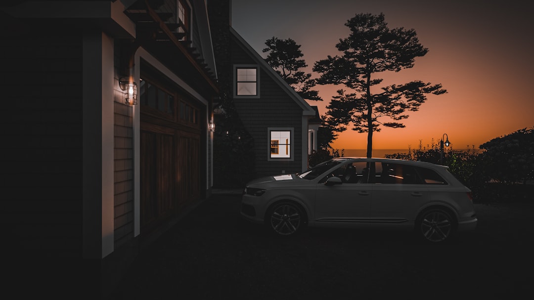 The striking exterior of a modern luxury home with architectural lighting illuminated at dusk, representing a high-value real estate asset at risk from costly mistakes.