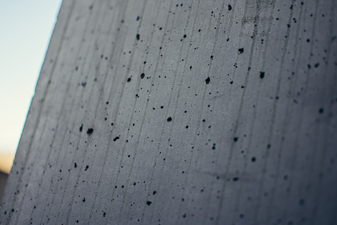 Close-up photograph of a cracked and crumbling concrete foundation of a house, symbolizing the slow erosion of home equity.