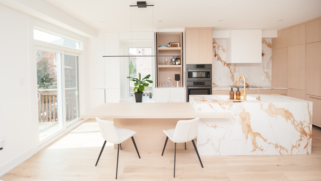 Sleek, modern house keys rest on a clean wooden surface, representing a new, efficient, and professional approach to selling a home.