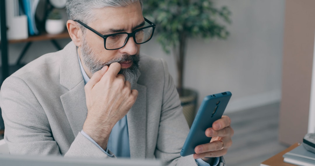 Homeowner looking concerned while reviewing a stack of official-looking documents at a clean, modern table, representing t...