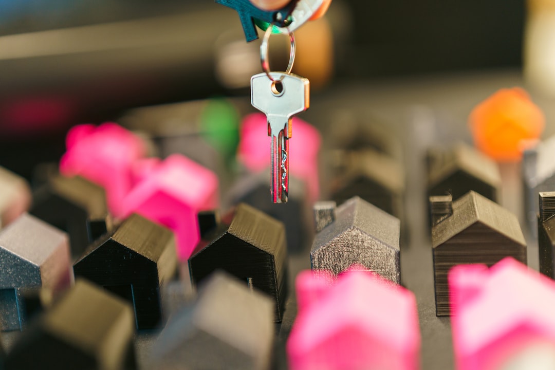 Sharply dressed professional in a modern office carefully analyzes a miniature model of a house, symbolizing a strategic, ...