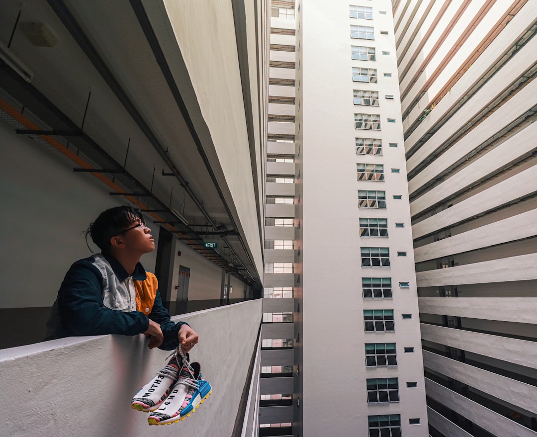 A man in a bright, modern setting has a look of concern and disbelief as he reviews a financial document, representing a homeowner questioning high fees.