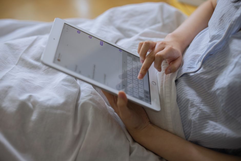 A person sitting in a modern living room uses a tablet to navigate a 3D virtual tour of a property, showcasing the technology that empowers today's home buyers.