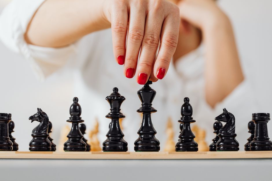 Single, minimalist chess piece making a strategic move on a brightly lit chessboard, symbolizing negotiation and advantage...