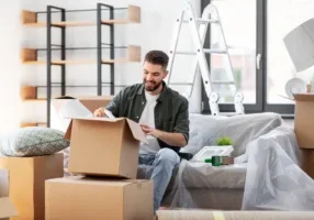 Man unpacking boxes at new home 2