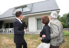 Real estate agent with senior couple buying new house