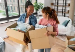 Women with boxes moving to new home