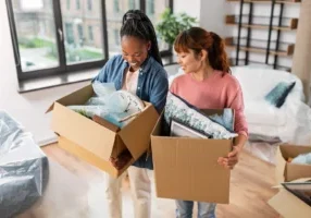 Women with boxes at new home